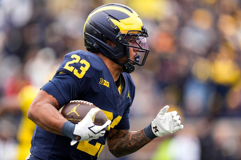Team Blue running back Jordan Marshall (23) runs the ball against Team Maize during the spring game at Michigan Stadium in Ann Arbor on Saturday, April 18, 2026.