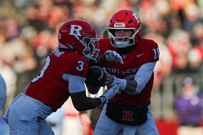 Nov 29, 2025; Piscataway, New Jersey, USA; Rutgers Scarlet Knights quarterback Athan Kaliakmanis (16) hands off to running back Antwan Raymond (3) during the first half against the Penn State Nittany Lions at SHI Stadium. Mandatory Credit: Vincent Carchietta-Imagn Images