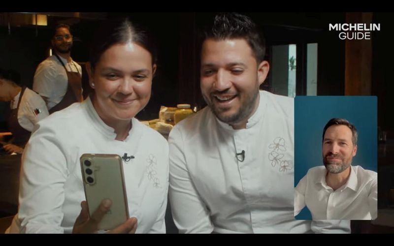 Emelina's husband and wife chefs Osmel Gonzalez and Camila Salazar react as Michelin Guide International Director Gwendal Poullennec announces their Michelin star win during the guide’s livestream reveal.