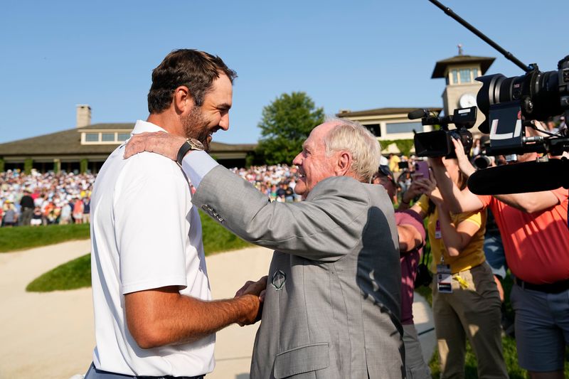 Scottie Scheffler gets a handshake from Jack Nicklaus after winning the 2025 Memorial Tournament at Muirfield Village Golf Club in Dublin, Ohio.