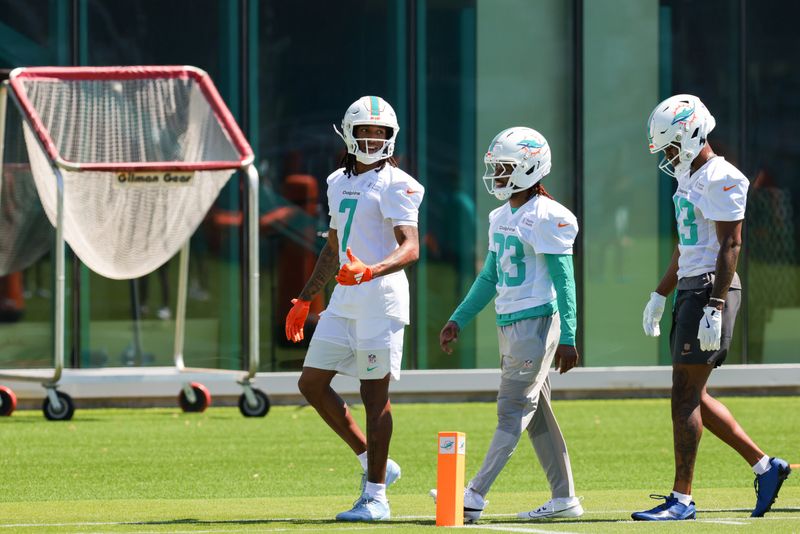 Miami Dolphins wide receiver Caleb Douglas (left), wide receiver Kevin Coleman Jr. (center) and wide receiver Donaven McCulley (right) work during rookie minicamp.