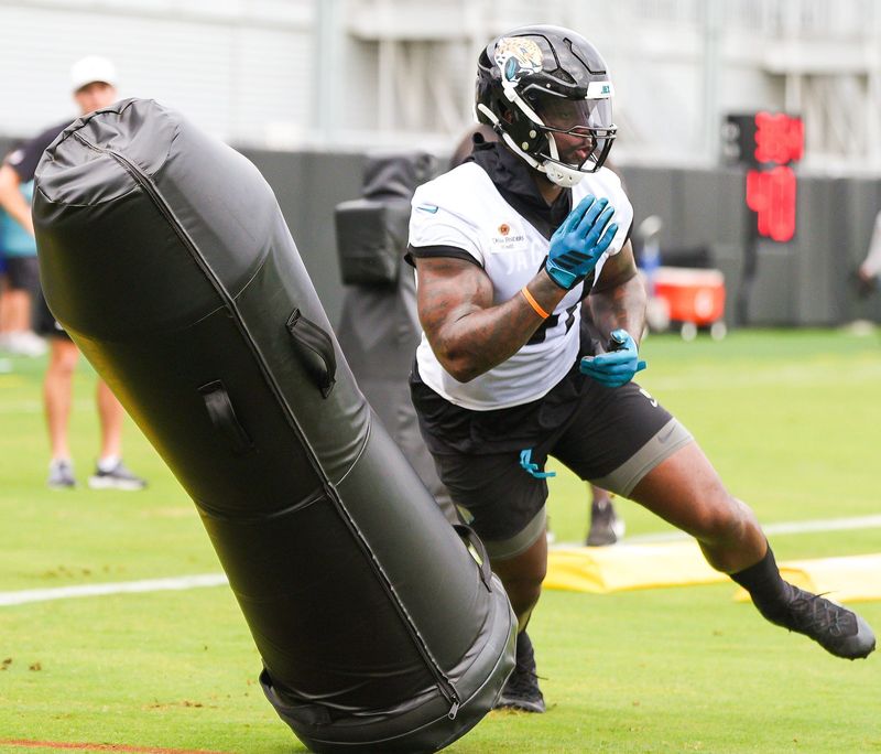 Jaguars defensive end Josh Hines-Allen (41) runs a drill with center Robert Hainsey (73) during the Jaguarsâ€™ fourth OTA of the year, Monday June 1, 2026 at the Miller Electric Center in Jacksonville, Fla. [Doug Engle/Florida Times-Union]