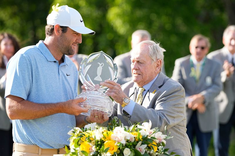 Scottie Scheffler receives the trophy from Jack Nicklaus after winning the Memorial Tournament in 2024.