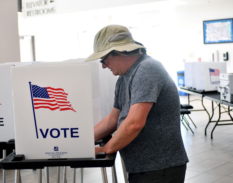Charles Hirtzel casts his vote early Tuesday morning at City Hall during this year's primary elections.