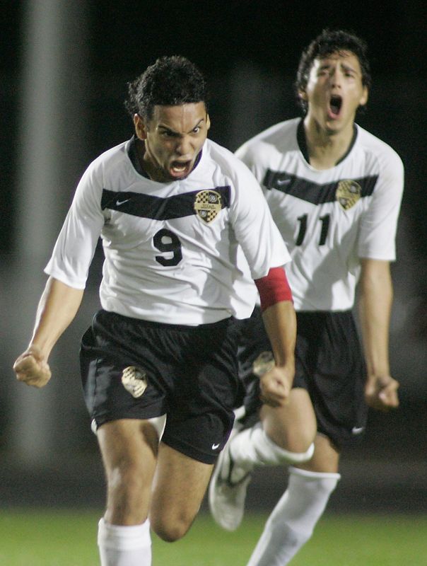 Golden Gate's Damian Coliqueo (9) and Luis Gonzales (11) celebrate after Coliqueo scored to put his team up 3-1 against Palmetto in the boys Class 4A-3 regional championship soccer game at Golden Gate High School on Friday February 8, 2008.