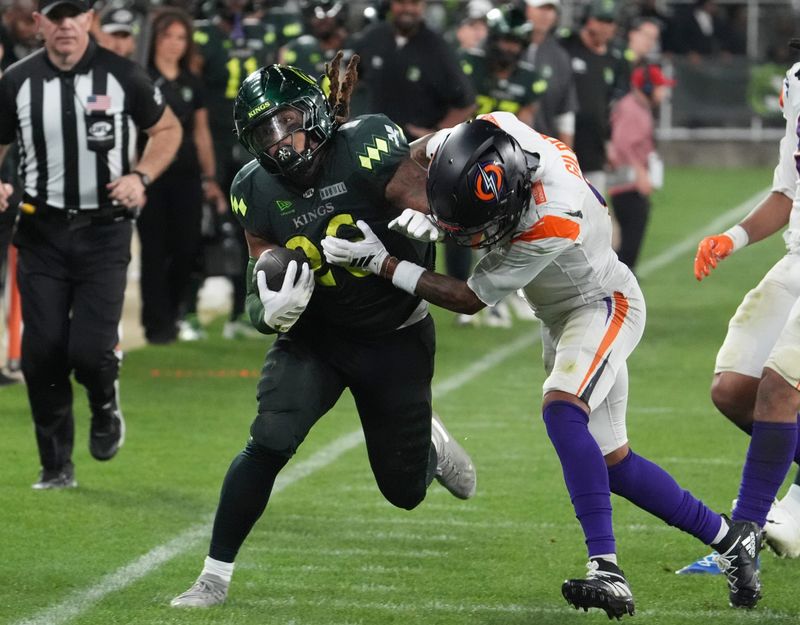 Louisville Kings running back Benny Snell runs against the Orlando Storm's Mark Gilbert at Lynn Family Stadium on April 10, 2026.