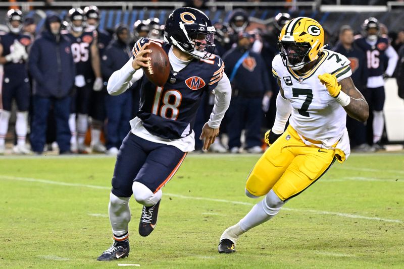 Jan 10, 2026; Chicago, IL, USA; Chicago Bears quarterback Caleb Williams (18) rolls out as Green Bay Packers linebacker Quay Walker (7) applies the pressure during the first half of an NFC Wild Card Round game at Soldier Field. Mandatory Credit: Matt Marton-Imagn Images
