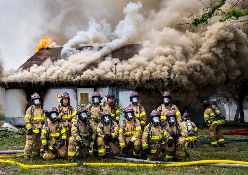 West Palm Beach firefighters pose for a quick group photo as fire burns an abandoned building used for training on June 2, 2026, in West Palm Beach, Florida. Related Ross provided the vacant buildings where a new Publix is planned.