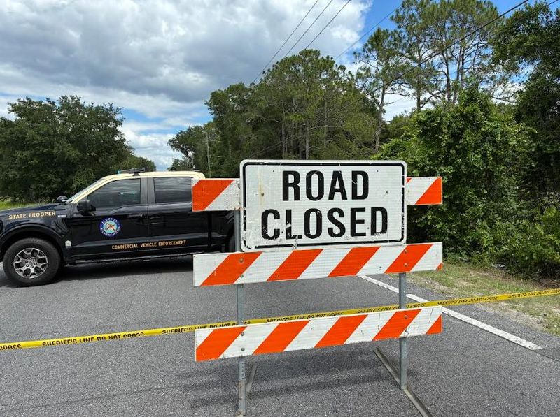 A road closed sign was placed along County Road 42 to prevent drivers from passing the spot where a two-vehicle crash killed one person and injured another on June 5, 2026.