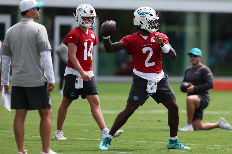 Jun 2, 2026; Miami Gardens, FL, USA; Miami Dolphins quarterback Malik Willis (2) prepares to throw the ball during mini camp as quarterback Quinn Ewers (14) watches at Baptist Health Training Complex. Mandatory Credit: Isabella Frias-Imagn Images