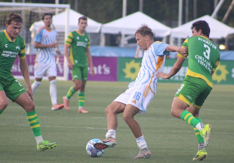 Sporting Club Jacksonville forward Emil Jaaskelainen (16) tries to hold possession as Tampa Bay Rowdies defender Brian Schaefer (3) challenges.