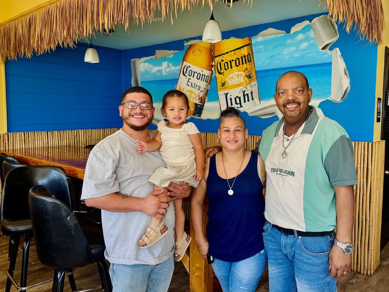 J&A Subs and More owner Isach Anaya (left) poses for a photo with his daughter and parents, Juan and Angelica Figueroa, at the new Daytona Beach Shores restaurant.