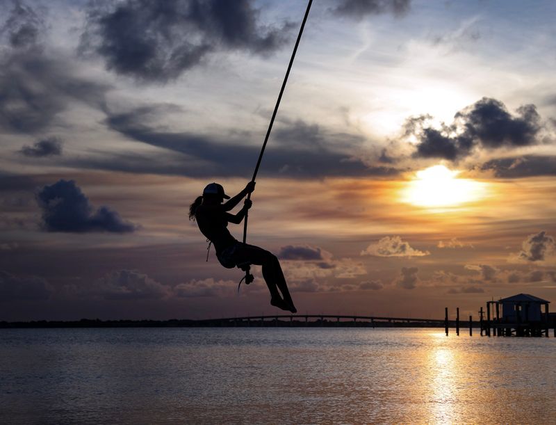 A teenager swings over the Indian River Lagoon as the sun is setting, June 8, 2026, on Hutchinson Island in Martin County. According to the Old Farmer’s Almanac, summer officially begins with the solstice on June 21, marking the astronomical first day of summer in the Northern Hemisphere. The Meteorological Summer begins June 1. According to NOAA, meteorologists and climatologists break the seasons down into groupings of three months based on the annual temperature cycle.