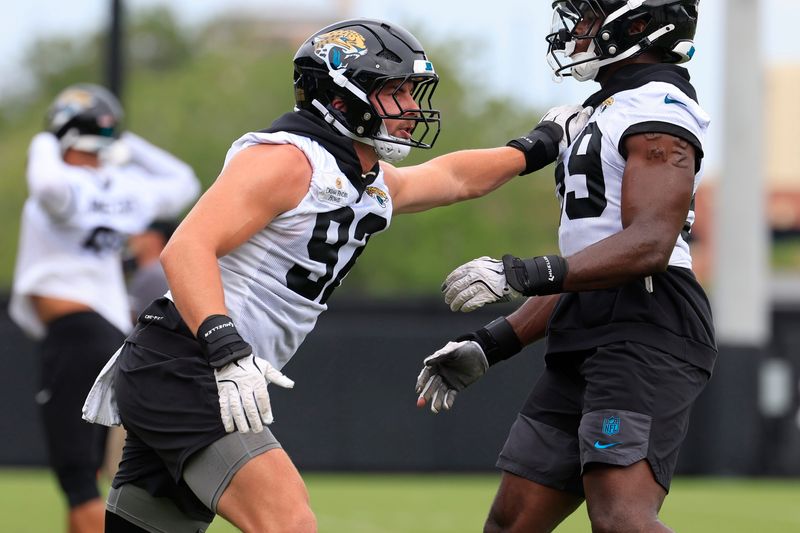 Jacksonville Jaguars defensive end Danny Striggow (92), left, drills on defensive end Quindarius Dunnigan (59) during the first day of minicamp at the Miller Electric Center, Tuesday, June 9, 2026, in Jacksonville, Fla.