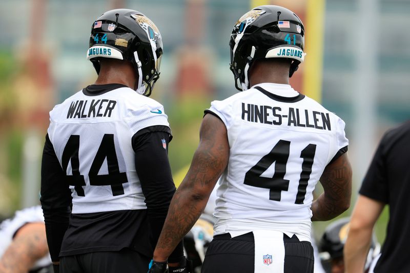 Jaguars defensive end Travon Walker (44) and defensive end Josh Hines-Allen (41) talk during the first day of minicamp at the Miller Electric Center.