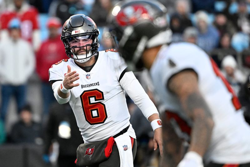 Dec 1, 2024; Charlotte, North Carolina, USA; Tampa Bay Buccaneers quarterback Baker Mayfield (6) signals to wide receiver Mike Evans (13) in the first quarter at Bank of America Stadium. Mandatory Credit: Bob Donnan-Imagn Images