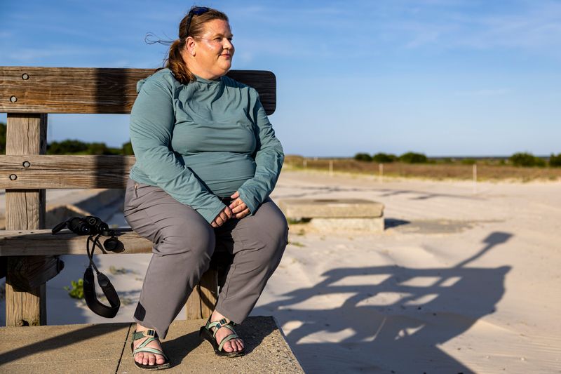Brittney Brown poses for a portrait near Pitcher Point in Pass Christian, Miss., on Thursday, June 4, 2026. Brown was fired from her position as a biologist in bird conservation for Florida Fish and Wildlife Conservation Commission after reposting an Instagram meme about whales feeling indifferent to Charlie Kirk's assassination. After a lawsuit, she received a settlement, but was not reinstated and currently works in Mississippi.
