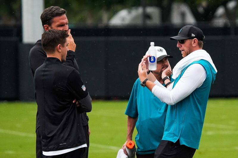 Jacksonville Jaguars head coach Liam Coen, right, talks with General Manager of the Jacksonville Jaguars James Gladstone, left and executive vice president of football operations Tony Boselli after the second day of minicamp at the Miller Electric Center, Wednesday, June 10, 2026, in Jacksonville. [Doug Engle/Florida Times-Union]