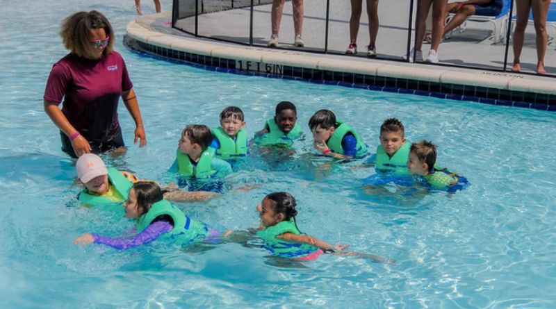 Children enjoy the pool under an adult's watchful eye