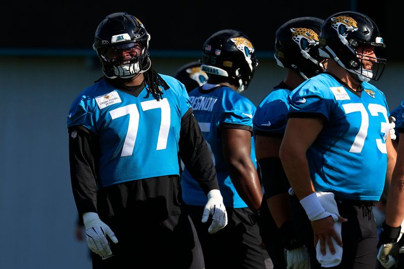 Jacksonville Jaguars offensive tackle Anton Harrison (77) looks on during the third day of minicamp at the Miller Electric Center, Thursday, June 11, 2026, in Jacksonville, Fla.