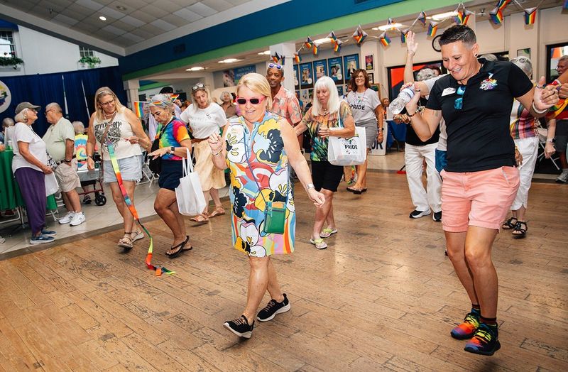 Senior Friendship Centers president and CEO Erin McLeod (sunglasses) steps up for some line dancing during Silver Pride 2026.