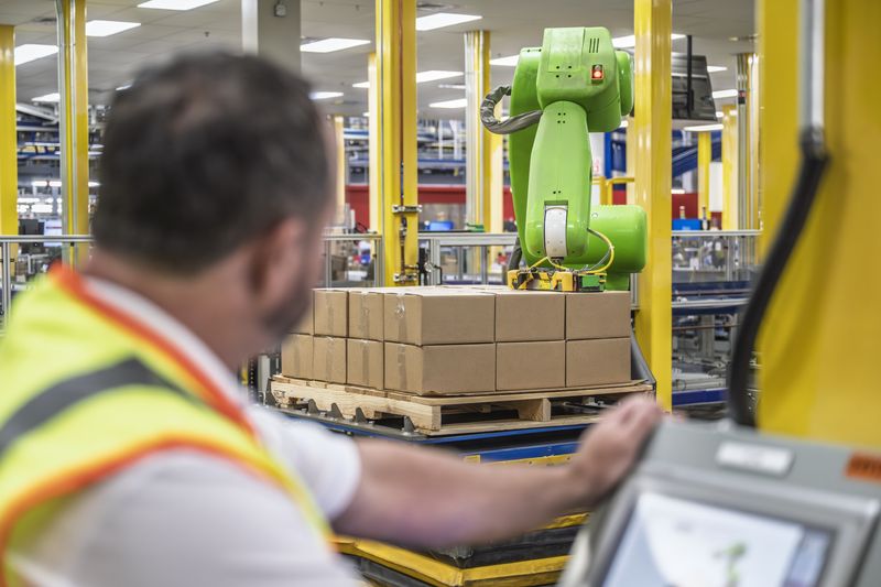 A Johnson & Johnson employee operates a robotic lift inside a Jacksonville facility for manufacturing and shipping ACUVUE contact lenses.