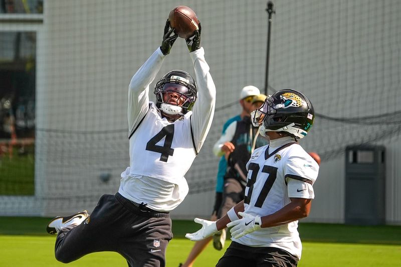 Jacksonville Jaguars cornerback Jarrian Jones (4) catches a pass over Jacksonville Jaguars cornerback Jabbar Muhammad (37) during a drill as the Jaguars held their final Organized Team Activity on Monday, June 15, 2026 at the Miller Electric Center in Jacksonville, Fla. [Doug Engle/Florida Times-Union]