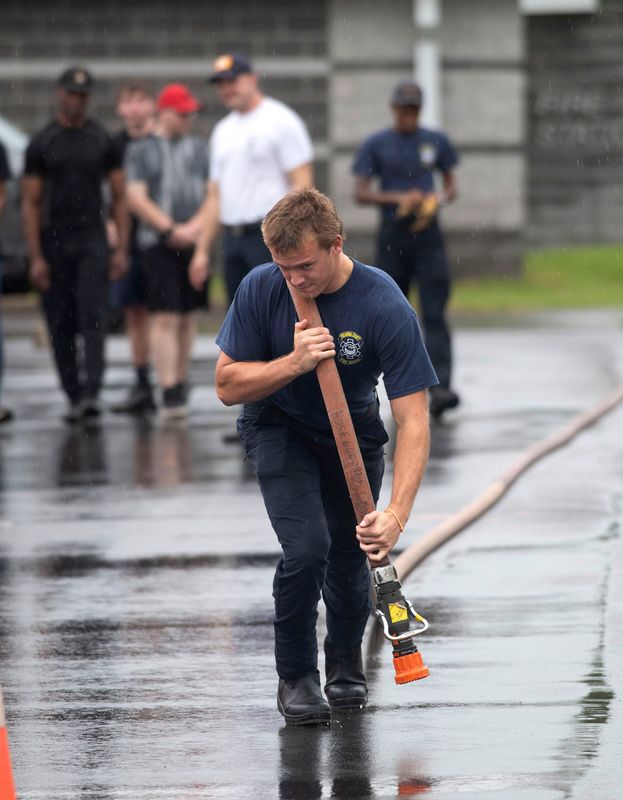An Escambia County Fire Rescue firefighter demonstrates the charged hose pull to job candidates during the physical abilities test for Florida-certified firefighters interested in joining ECFR on June 15, 2026. The physical abilities test evaluates the firefighter hopefuls in a variety of tasks, including the charged hose pull, victim rescue, and high-rise hose carry, at the Pensacola Fire Department Station 4.