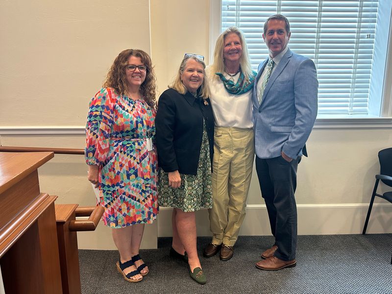 Town Clerk Kelly Churney, Mayor Danielle Moore, Sarah Jane Mettler Cecil and Paul Colby, from left, celebrate the presentation of three Thomas Mettler Memorial Scholarships to children of town staff June 9.