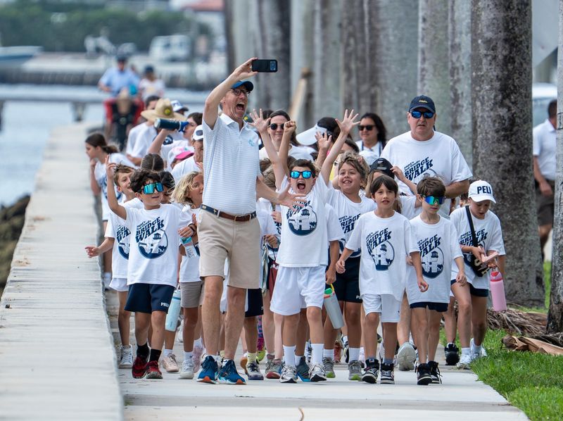 Head of School Fanning Hearon takes a selfie with third graders along Flagler Drive at the start of the 2026 Bridge Walk event on June 10.
