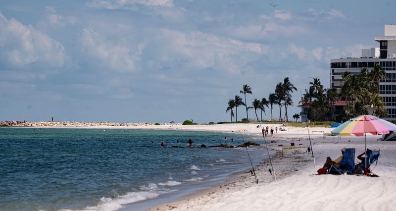 Visitors enjoy the beach near Lowdermilk Park in Naples on Monday, June 15, 2026.