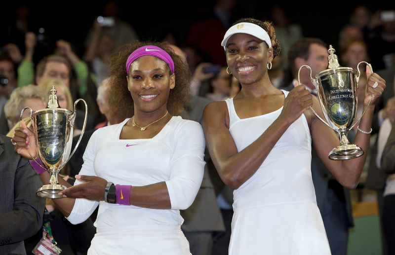 July 7, 2012; London, UNITED KINGDOM; Serena Williams (USA), left, and Venus Williams (USA) pose with their trophies after defeating Andrea Hlavackova (CZE) and Lucie Hradecka (CZE) in the women's doubles finals of the 2012 Wimbledon Championships at the All England Lawn Tennis Club. Mandatory Credit: Susan Mullane-USA TODAY Sports