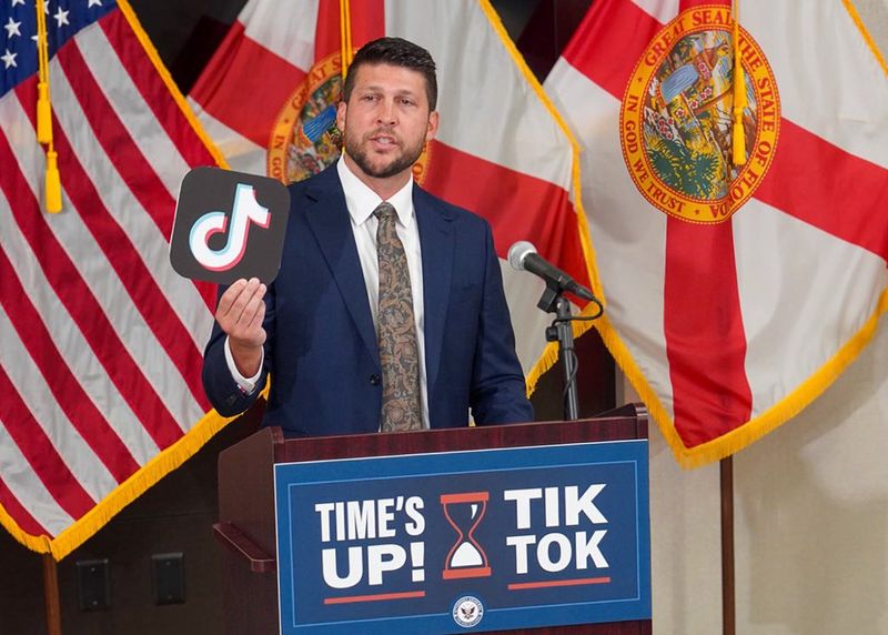 Florida Attorney General James Uthmeier holds up a TikTok logo as he announces the state's lawsuit against the social media giant on Monday, June 15, 2026.