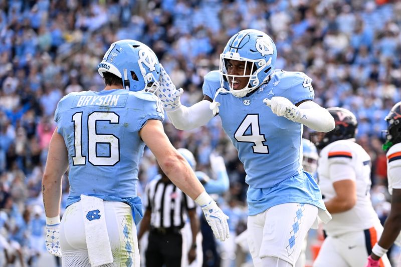 Oct 25, 2025; Chapel Hill, North Carolina, USA; North Carolina Tar Heels defensive back Coleman Bryson (16) and linebacker Mikai Gbayor (4) react in the fourth quarter at Kenan Stadium. Mandatory Credit: Bob Donnan-Imagn Images