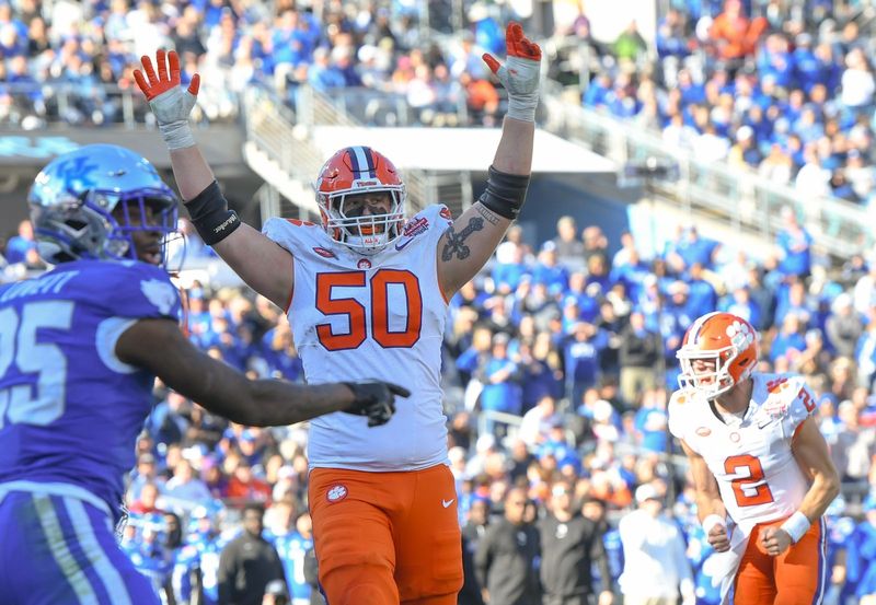 Clemson offensive lineman Collin Sadler (50) celebrates after running back Phil Mafah (7) scored his fourth touchdown against Kentucky during the fourth quarter of the TaxSlayer Gator Bowl at EverBank Stadium in Jacksonville, Florida, Friday, December 29, 2023. Clemson won 38-35.
