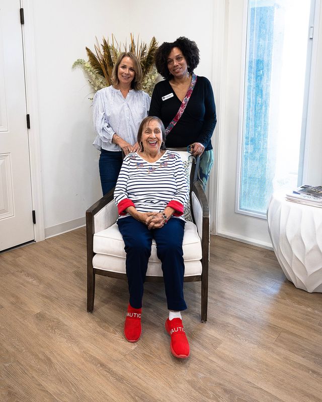 Jodie Rhea, sitting, has her photo taken with daughter, Cindy Horne, and Carolyn Stewart, director of activities at The Blake, in Panama City Beach, Florida, June 17, 2026. Rhea, 89, lives with Alzheimer's disease and will help fundraise for a cure during The Blake's third annual walk on June 21. (Tyler Orsburn/Panama City News Herald)