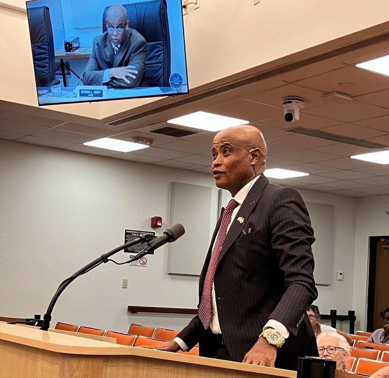 Internal City Auditor Abinet Belachew speaks to the Daytona City Commission on June 17. Mayor Derrick Henry is shown on the TV screen.
