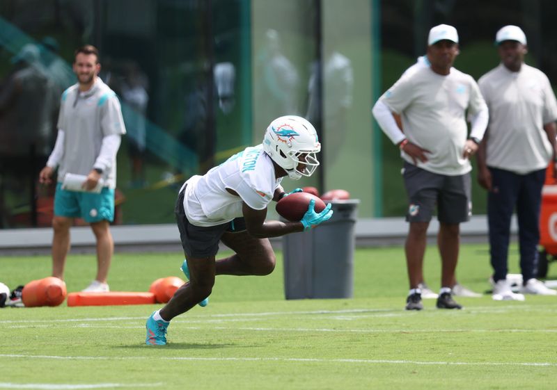 Jun 2, 2026; Miami Gardens, FL, USA; Miami Dolphins wide receiver Malik Washington (6) catches a ball during mini camp as coaching staff watches at Baptist Health Training Complex. Mandatory Credit: Isabella Frias-Imagn Images