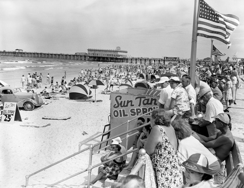 A big crowd converges on the Boardwalk on July 4, 1949. Note the 25-cent suntan oil spray booth. Some 49,000 people jammed the beach that holiday.