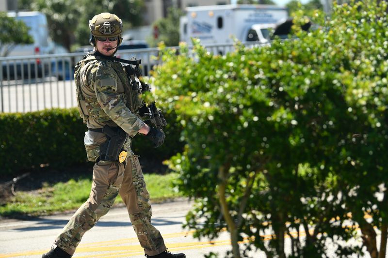 A police officer in tactical gear approaches the kava bar in a shopping center at 625 N. Atlantic Ave. in Cocoa Beach.