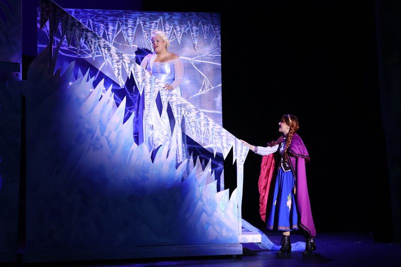 Anna (Tori Weatherington) and Elsa (Maria Malley) on the staircase in "Frozen: The Broadway Musical," being present at Leon High School beginning at 7 p.m. June 25, 2026
