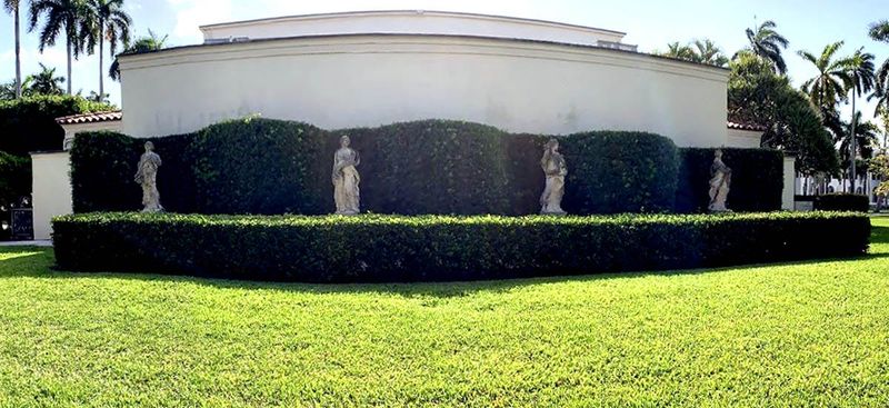 Four classical statues depicting the seasons stand outside the Esther B. O’Keeffe Building at the Society of the Four Arts in Palm Beach before they were removed and stored to accommodate a major renovation project.