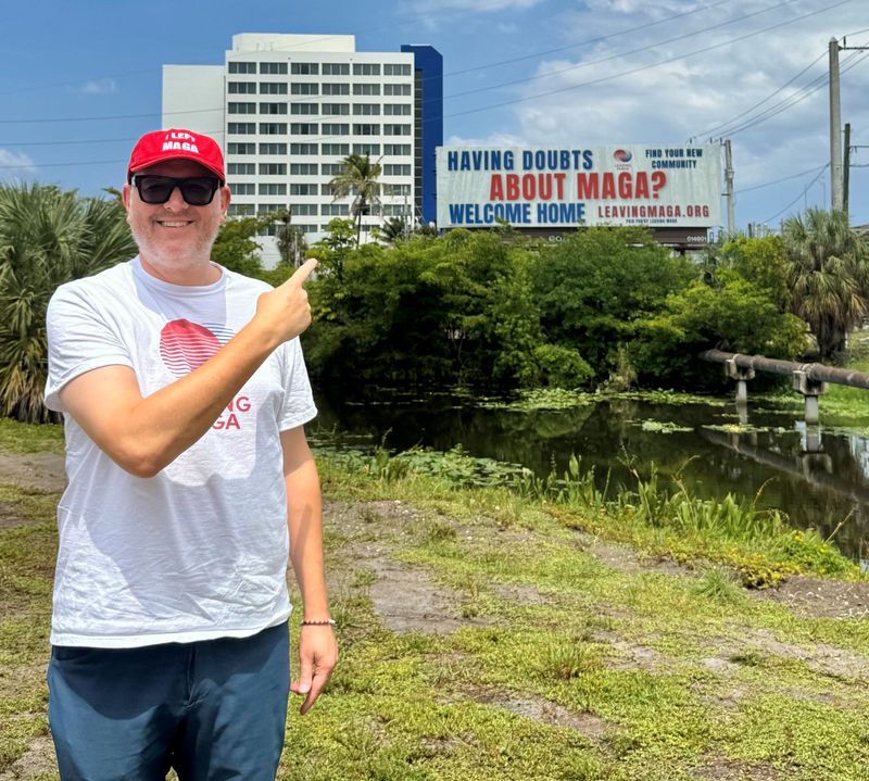 Rich Logis, founder of LeavingMAGA.org, stands in front of one of his organization's billboards in West Palm Beach. Leaving MAGA has erected billboards in 18 states.
