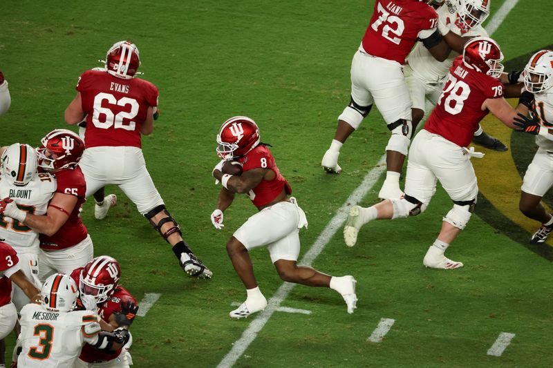 Jan 19, 2026; Miami Gardens, FL, USA; Indiana Hoosiers running back Kaelon Black (8) carries the ball against the Miami Hurricanes in the second quarter during the College Football Playoff National Championship game at Hard Rock Stadium. Mandatory Credit: Kim Klement Neitzel-Imagn Images