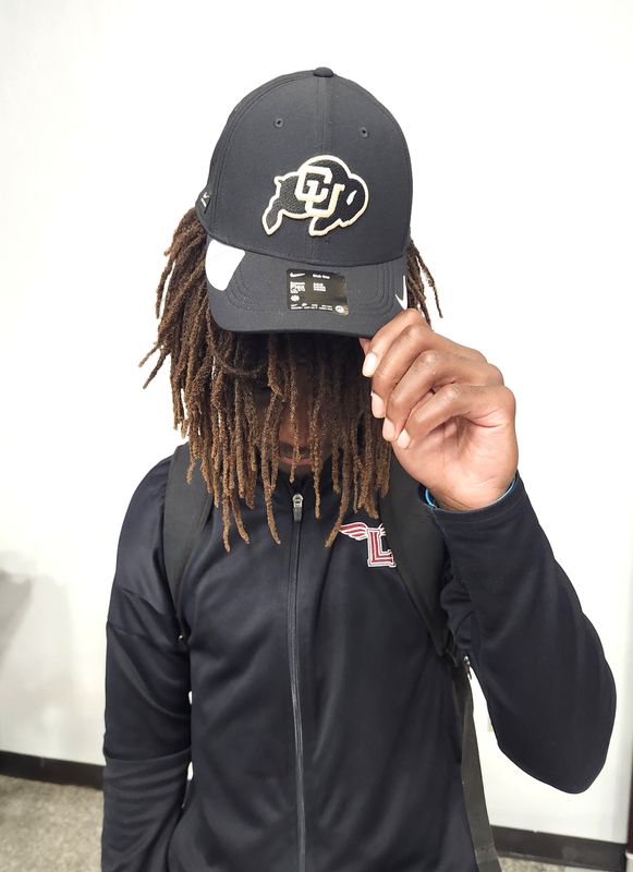 Palm Beach Lakes receiver Ryan Ferdinand poses with a Colorado hat after committing on June 26, 2026.