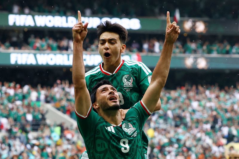 Mexico's Raul Jimenez celebrates scoring El Tri's second goal with Gilberto Mora.