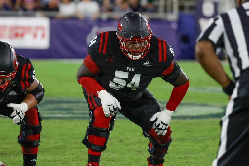 Nov 1, 2024; Boca Raton, Florida, USA;  Florida Atlantic Owls offensive lineman Jordan Church (54) gets ready for the snap during the second quarter against the South Florida Bulls at FAU Stadium. Mandatory Credit: Reinhold Matay-Imagn Images
