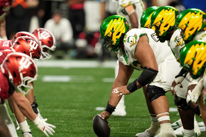 Jan 9, 2026; Atlanta, GA, USA; Oregon Ducks offensive lineman Iapani Laloulu (72) prepares to snap the ball against the Indiana Hoosiers during the third quarter of the 2025 Peach Bowl and semifinal game of the College Football Playoff at Mercedes-Benz Stadium. Mandatory Credit: Dale Zanine-Imagn Images