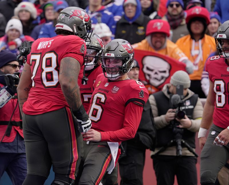 Tampa Bay Buccaneers quarterback Baker Mayfield celebrates with teammates including Tampa Bay Buccaneers offensive tackle Tristan Wirfs after the team scored a touchdown during first half action against the Tampa Bay Buccaneers on Nov 16, 2025 at Highmark Stadium in Orchard Park.