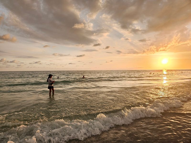 Sunset colors reflect off the Gulf waters at Lido Beach in Sarasota on June 27, 2026.